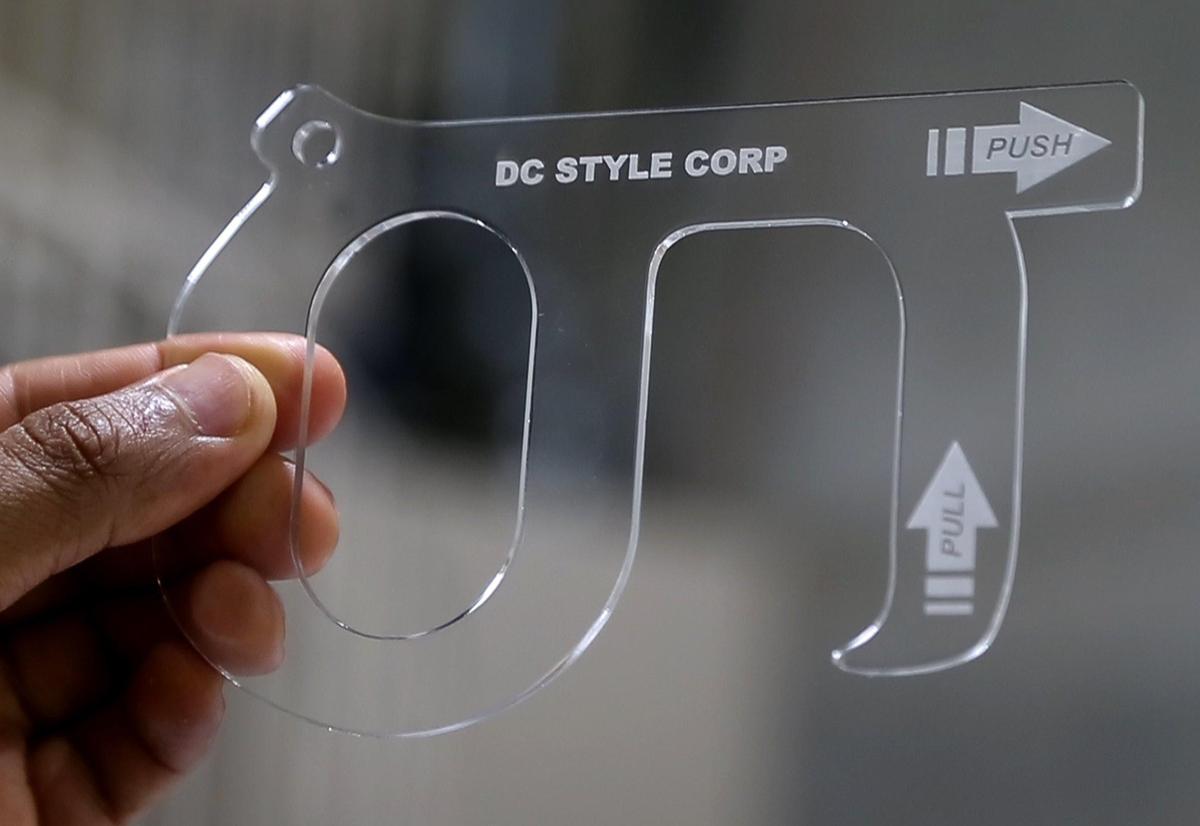 Una llavecita Keysmart que fabrica la compañía DC Style, que le permite a las personas evitar tocar los botones y las manijas de las puertas.