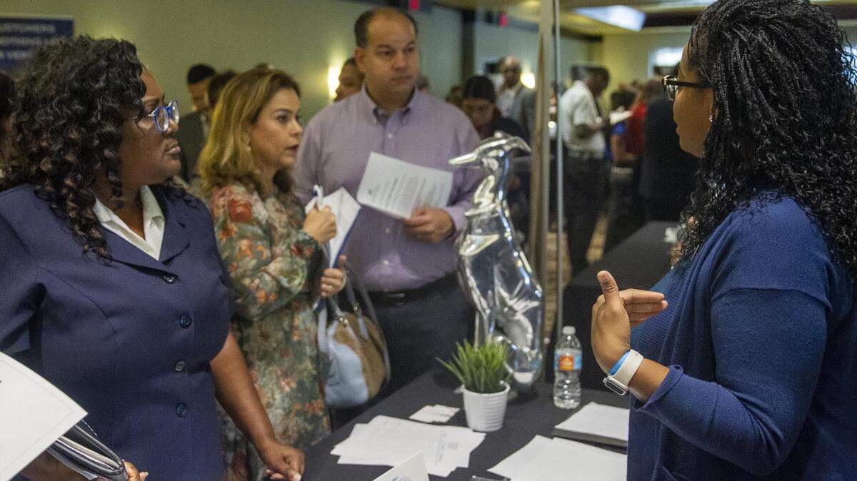 John Paul recruiter Alisha Leben, right, talks to interested applicants during a job fair at Shula’s Hotel and Golf Club in Miami Lakes, Florida, on Wednesday, July 10, 2019.