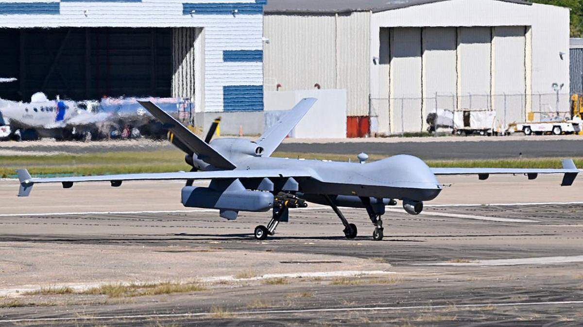 A US military MQ-9 Reaper drone taxis on a tarmac at Rafael Hernandez Airport in Aguadilla, Puerto Rico, on December 29, 2025. The United States has deployed a major military force in the Caribbean and has recently intercepted oil tankers as part of a naval blockade against Venezuelan vessels it considers to be under sanctions. Since September, US forces have launched dozens of air strikes on boats that Washington alleges, without showing evidence, were transporting drugs. More than 100 people have been killed. (Photo by Miguel J. Rodriguez Carrillo / AFP via Getty Images)