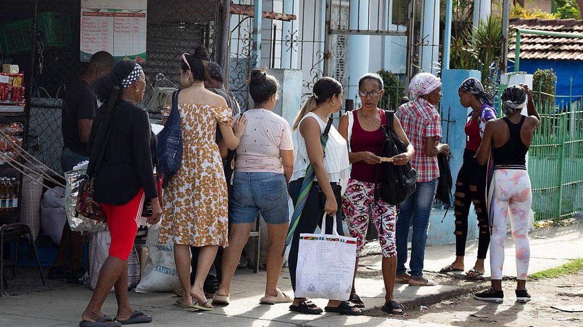 People buy food ahead of the arrival of Tropical Storm Melissa in Santiago de Cuba on October 25, 2025. Cuba has begun preparations to face the impact of Tropical Storm Melissa in at least two provinces in the central and eastern parts of the island, as the storm moves toward Jamaica. (Photo by AFP) (Photo by STRINGER/AFP via Getty Images)