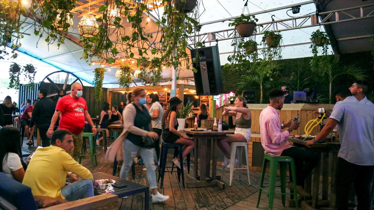 Patrons at The Deck, a restaurant and bar inside Wynwood Marketplace, an open-air destination in the trendy Miami neighborhood. Despite larger crowds, hospitality employers are finding it hard to fill open job roles.