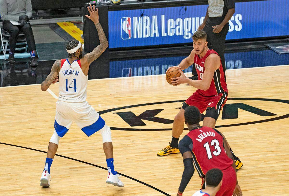 Miami Heat forward Meyers Leonard (0) looks to pass the ball against New Orleans Pelicans forward Brandon Ingram (14) in the third quarter of a NBA basketball game on Christmas Day at the AmericanAirlines Arena on Friday, December 25, 2020.