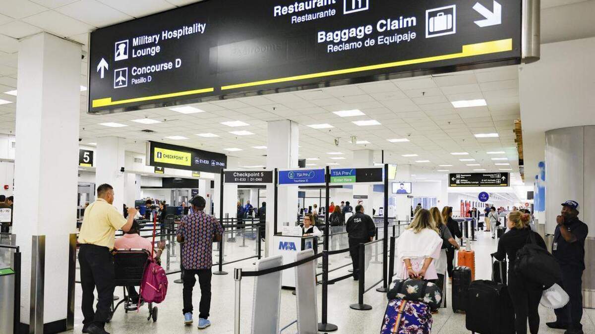 Viajeros pasan por las cortas filas de los controles de la TSA en el Aeropuerto Internacional de Miami, durante la mañana del lunes 23 de marzo de 2026.