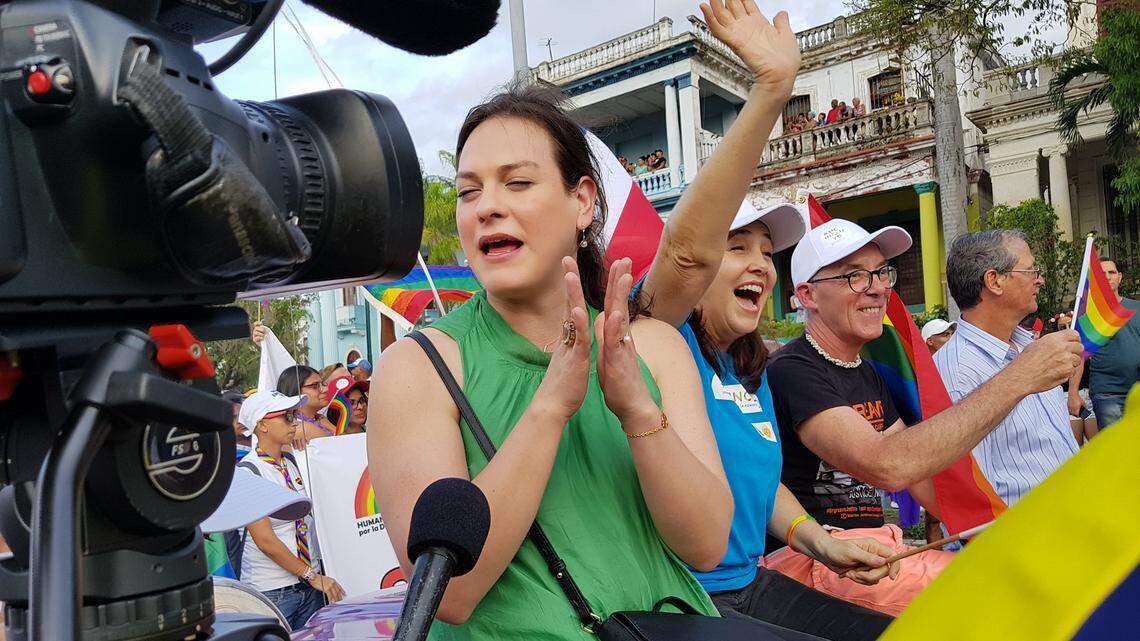 In this file photo Mariela Castro, at the center wearing a blue shirt, waves while riding in a classic American car during a Journey Against Homophobia and Transphobia parade in Havana.
