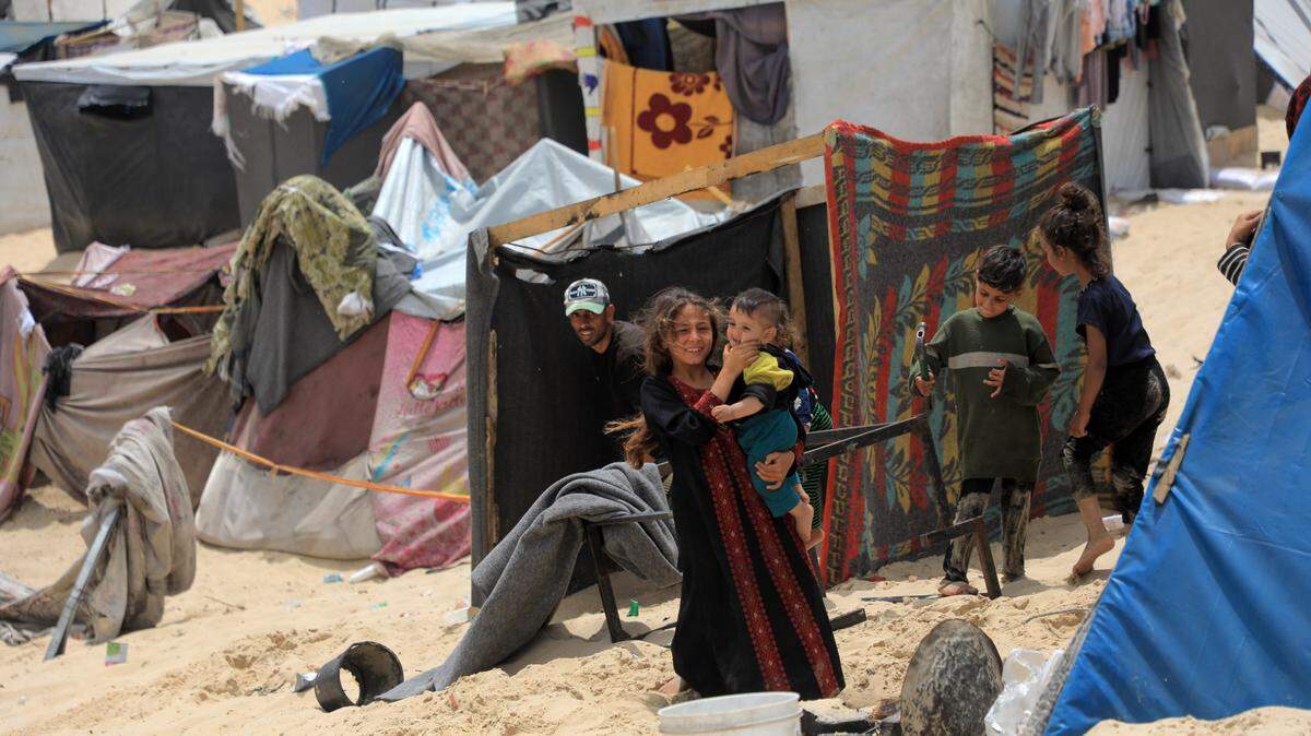 Un grupo de niños camina por un refugio temporal para palestinos desplazados por la guerra, en la ciudad de Rafah, en el sur de Gaza, el domingo 28 de abril de 2024.