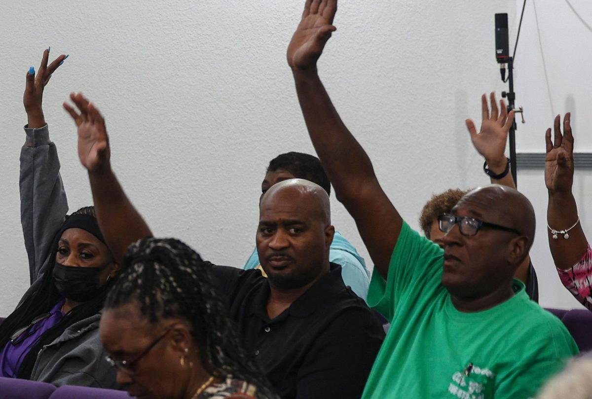 People from the Brownsville community raise their hands to reject Hialeah’s plan to incorporate part of the Brownsville territory during a press conference on Monday, April 24, 2023 at Brownsville Church of Christ. The area includes industrial sheds, also houses and the church.