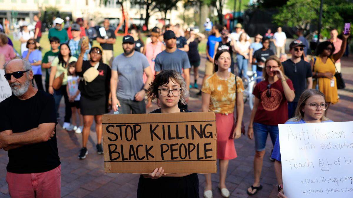 Hundreds of people gather at James Weldon Johnson Park in Jacksonville Florida, in August, to protest the murder of three Black people.