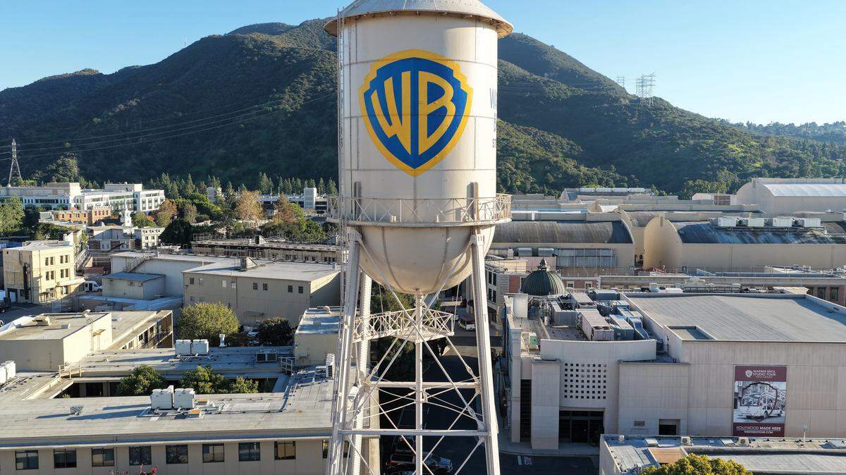 BURBANK, CALIFORNIA - DECEMBER 05: An aerial view of the Warner Bros. logo displayed on the water tower at Warner Bros. Studio on December 5, 2025 in Burbank, California. Netflix and Warner Bros. Discovery, Inc. have announced an $82.7 billion deal for Netflix to acquire Warner Bros. film and TV studios, HBO Max, and HBO. (Photo by Mario Tama/Getty Images)