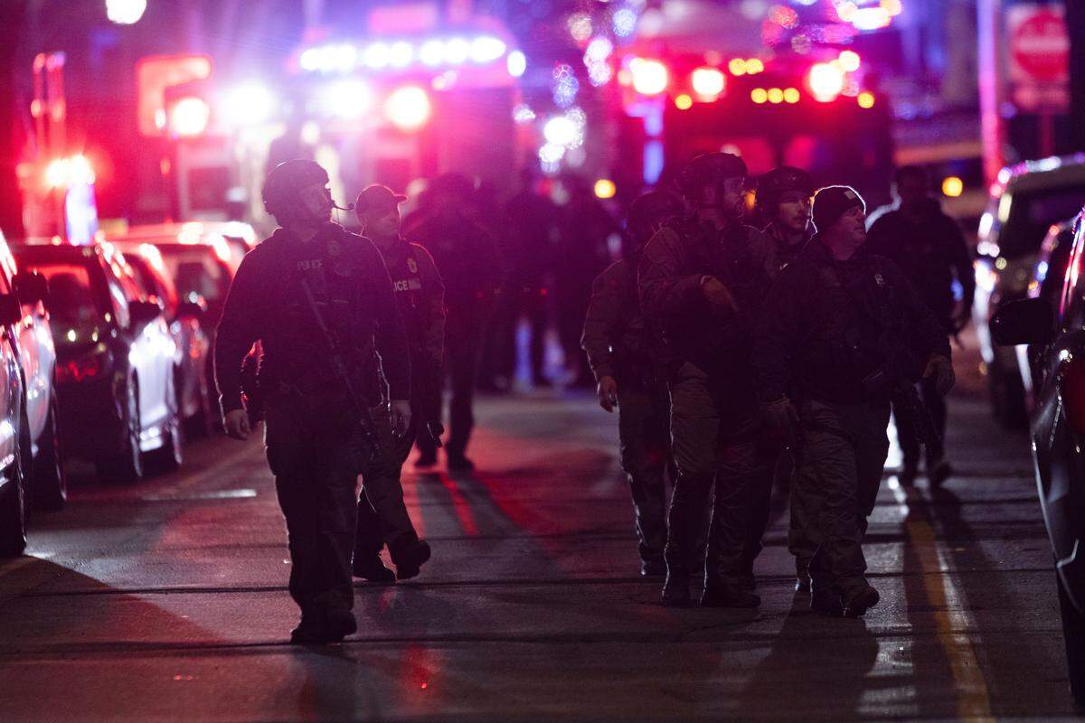 PROVIDENCE, RHODE ISLAND - DECEMBER 13: Police officers remain on the scene of a shooting that killed two and wounded at least eight at Brown University on December 13, 2025 in Providence, Rhode Island. Students remain locked in their dorms as police search for the suspect. (Photo by Libby O'Neill/Getty Images)