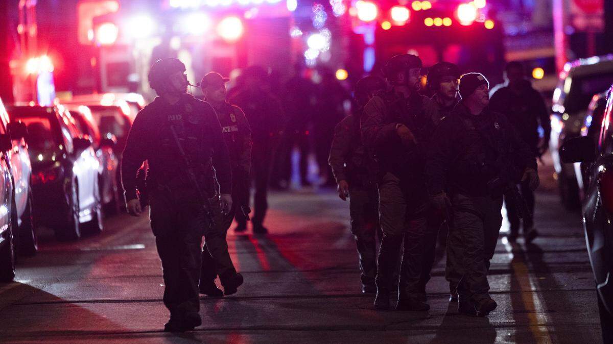 PROVIDENCE, RHODE ISLAND - DECEMBER 13: Police officers remain on the scene of a shooting that killed two and wounded at least eight at Brown University on December 13, 2025 in Providence, Rhode Island. Students remain locked in their dorms as police search for the suspect. (Photo by Libby O'Neill/Getty Images)