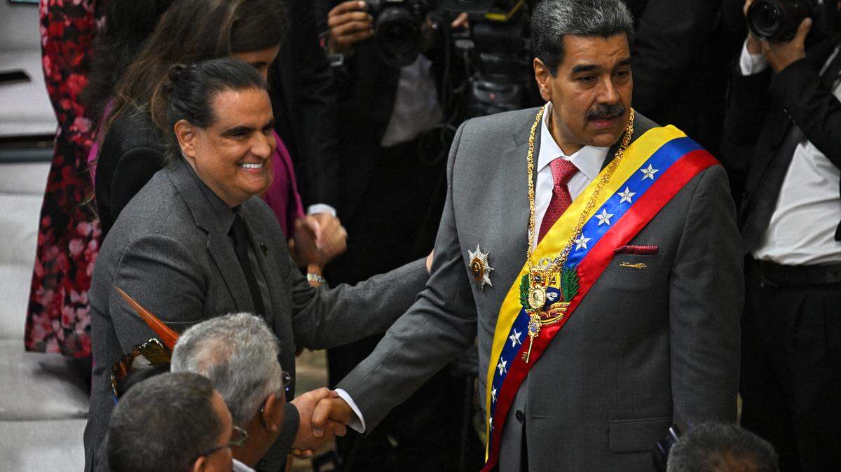 Venezuelan President Nicolas Maduro shakes hands with Colombian-born businessman Alex Saab upon arriving at the National Assembly headquarters to give his state of the nation address in Caracas on Jan. 15, 2024. 