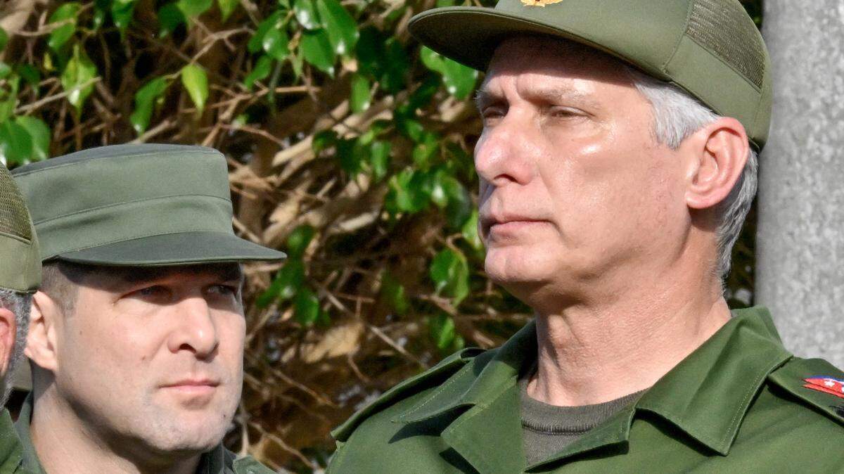 Cuba's President Miguel Diaz-Canel (R) and Cuba's Colonel Raul Guillermo Rodriguez Castro,  grandson of former President Raul Castro, attend the funeral of the 32 Cuban soldiers killed during the US incursion in Venezuela at Colon cemetery in Havana on January 16, 2026. (Photo by ADALBERTO ROQUE / AFP via Getty Images)