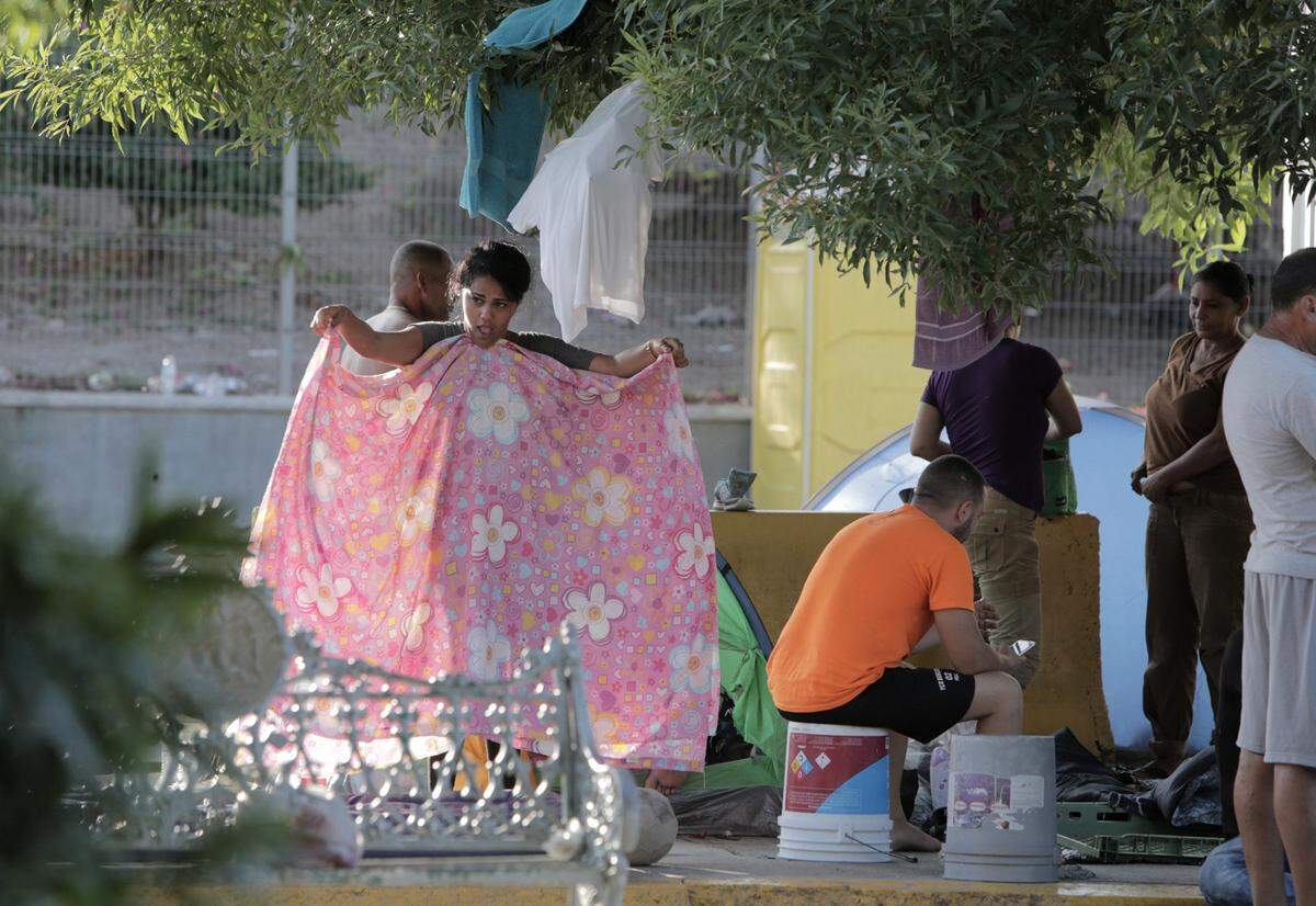 Cuban migrants sleeping in a small camp on the side of the Gateway International Bridge in Matamoros, Mexico, prepare to face another day of waiting for their number to be called so they can ask for political asylum in the United States. The Gateway International Bridge is one of three international bridges that cross the U.S.-Mexico border between the cities of Brownsville, Texas, and Matamoros, Tamaulipas.