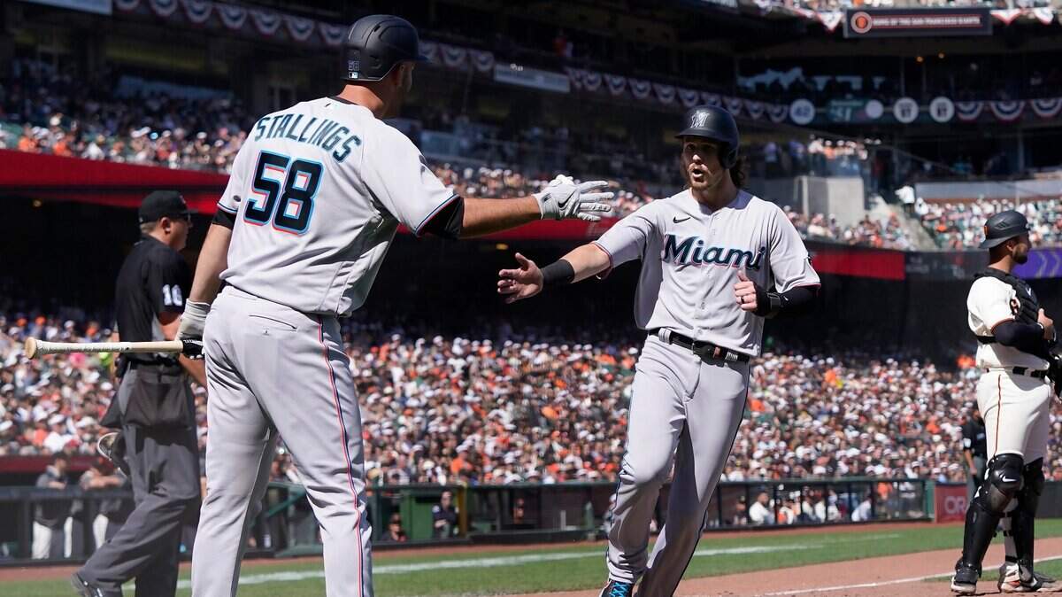 Brian Anderson recibe el saludo de Jacob Stallings tras anotar en el séptimo inning la carrera que le dio el triunfo a los Marlins 2-1 ante los Gigantes, en el partido celebrado el 9 de abril de 2022 en San Francisco.