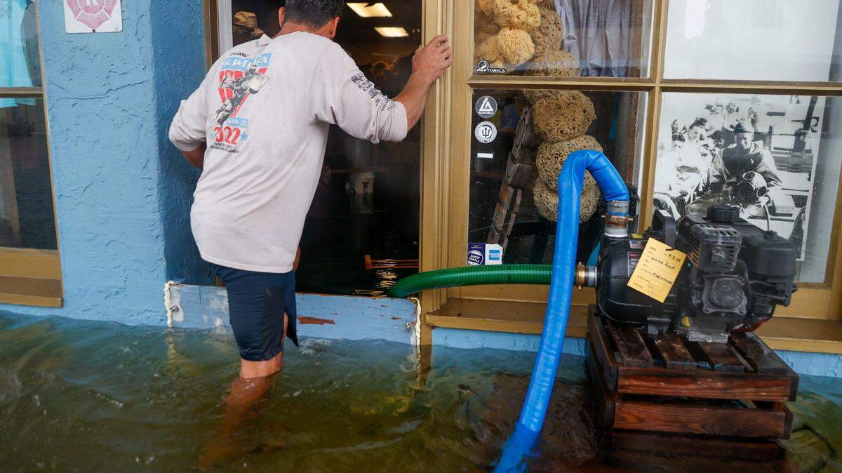 Sponge Diver Supply owner works to deal with the storm surge from Hurricane Idalia in Tarpon Springs on Aug. 30, 2023.