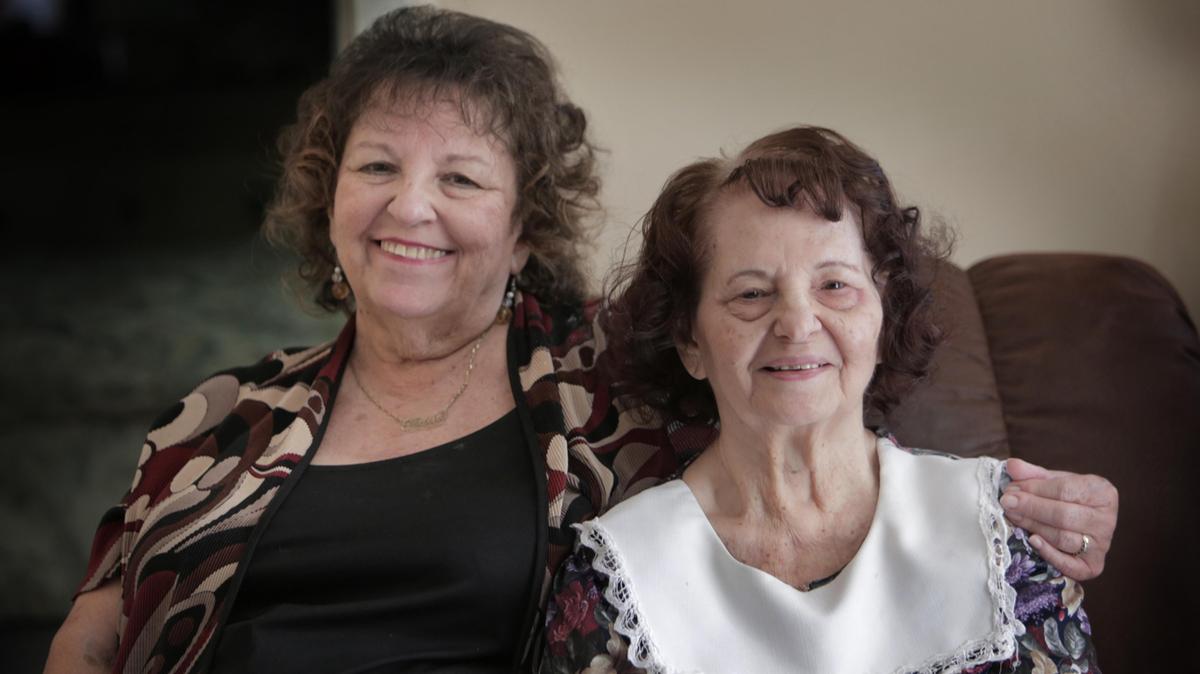 Damaris Pelay, right, 84, has been diagnosed with senile dementia and can no longer care for herself. Her younger sister, Gloria Gonzalez, left, cares for her but needs help with obtaining basic goods like blankets and a microwave oven.