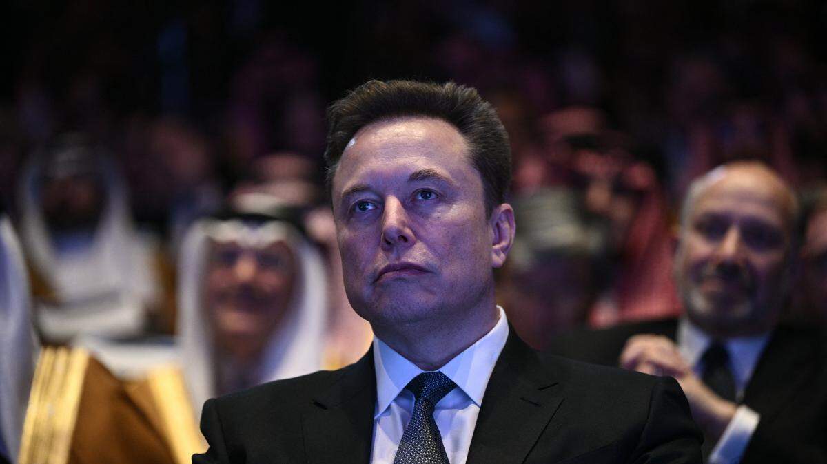 Elon Musk looks on as US President Donald Trump speaks at the US-Saudi Investment Forum at the John F. Kennedy Center for the Performing Arts in Washington, DC on November 19, 2025. (Photo by Brendan SMIALOWSKI / AFP) (Photo by BRENDAN SMIALOWSKI/AFP via Getty Images)