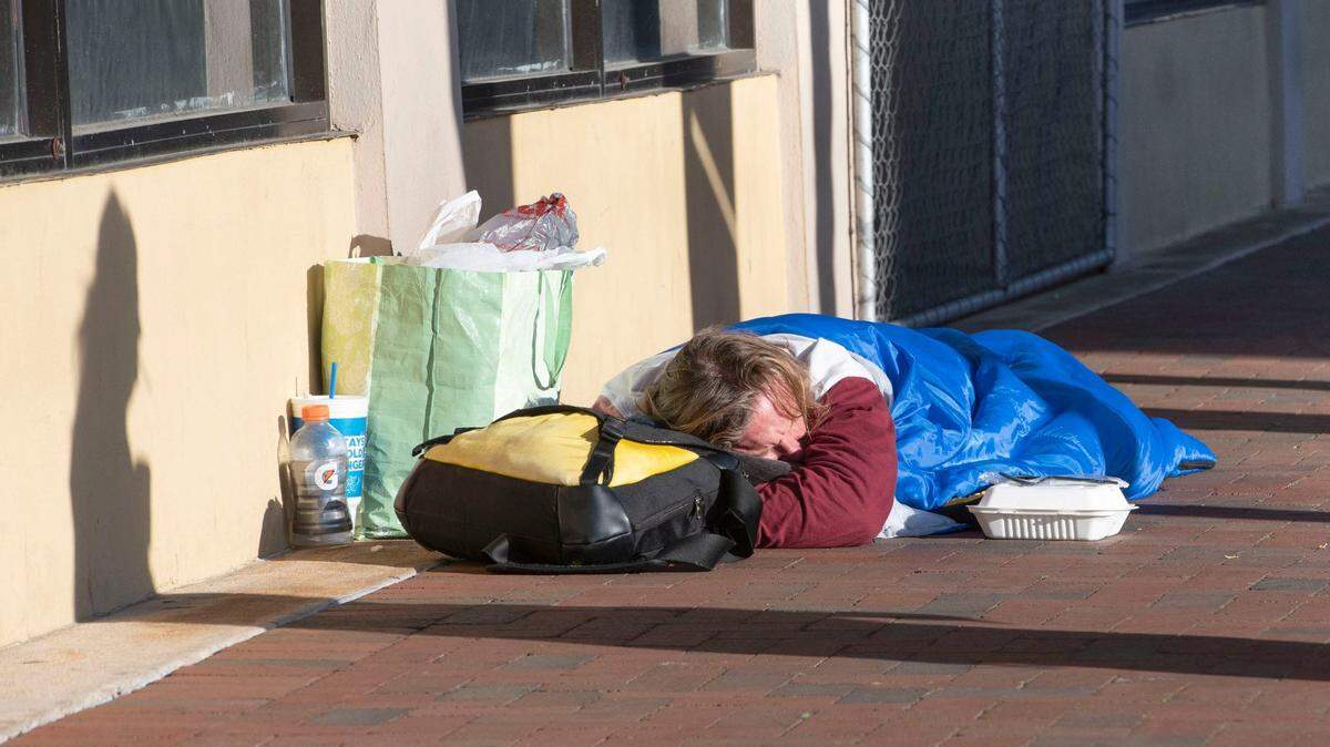 Una persona sin hogar duerme en la acera de la calle Palafox el 12 de marzo de 2024. 
