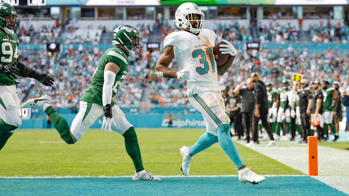 Miami Dolphins running back Raheem Mostert (31) scores in the first half against the New York Jets at Hard Rock Stadium in Miami Gardens, Florida on Sunday, December 17, 2023.