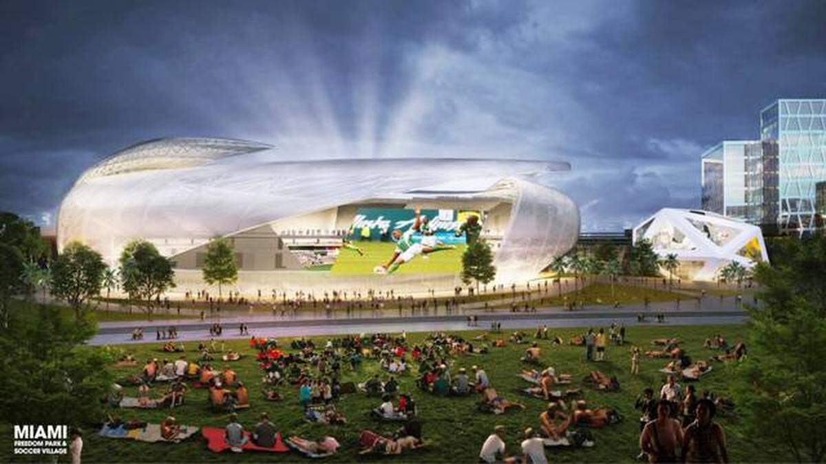 Esta representación arquitectónica muestra el exterior del estadio de fútbol propuesto con 25,000 asientos y una vista desde el parque público adyacente, donde los visitantes podrán ver los juegos proyectados en una pantalla de forma gratuita.