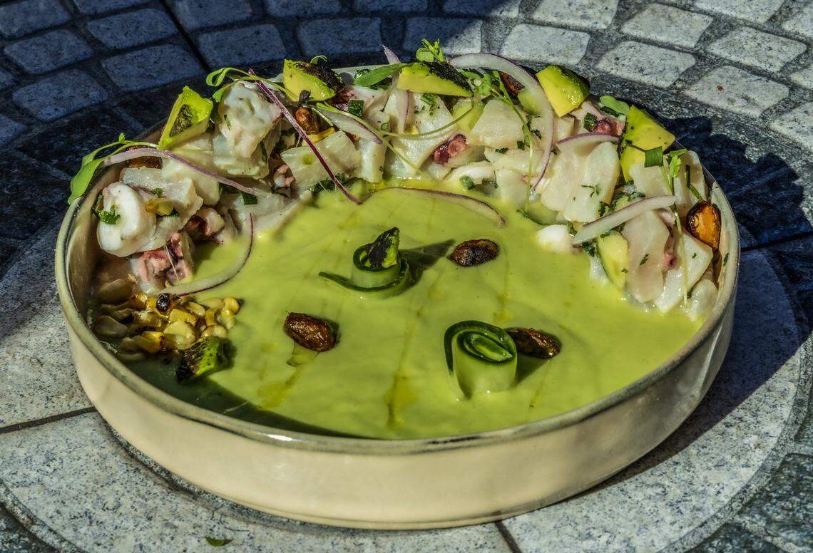 A ceviche verde - octopus and corvina in a green lime sauce, roasted elote, baby cucumber, charcoal avocado, red onions, sweet pistachio, orange oil and micro cilantro -  by chef Jonathan Arenas, from Mayami Wynwood.