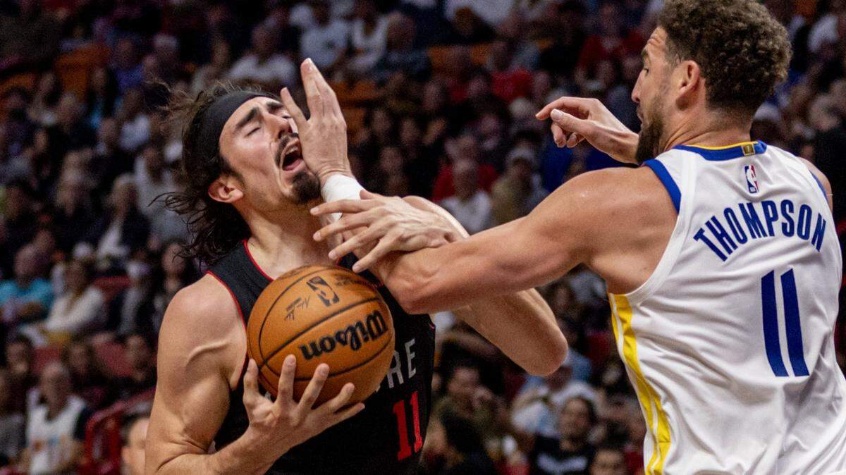 El jugador del Heat Jaime Jáquez Jr. (izq.) recibe una falta de Klay Thompson, de los Warriors de Golden State, en el partido celebrado el 26 de marzo de 2024 en Miami.