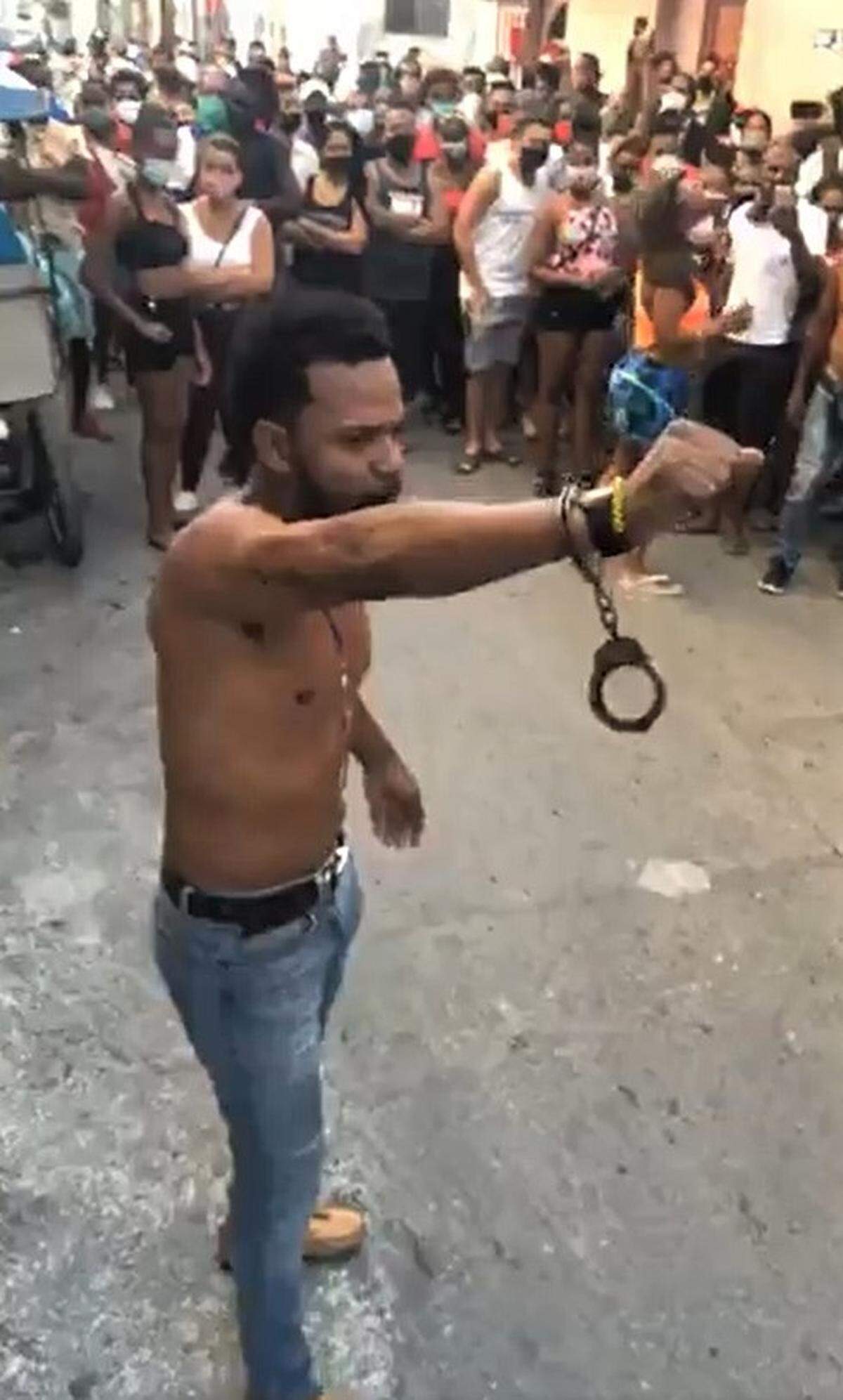 Rapper Maykel “Osorbo” Castillo raises his arm, showing a pair of handcuffs around one wrist, after authorities tried to arrest him on April 4, 2020, in Havana, Cuba.