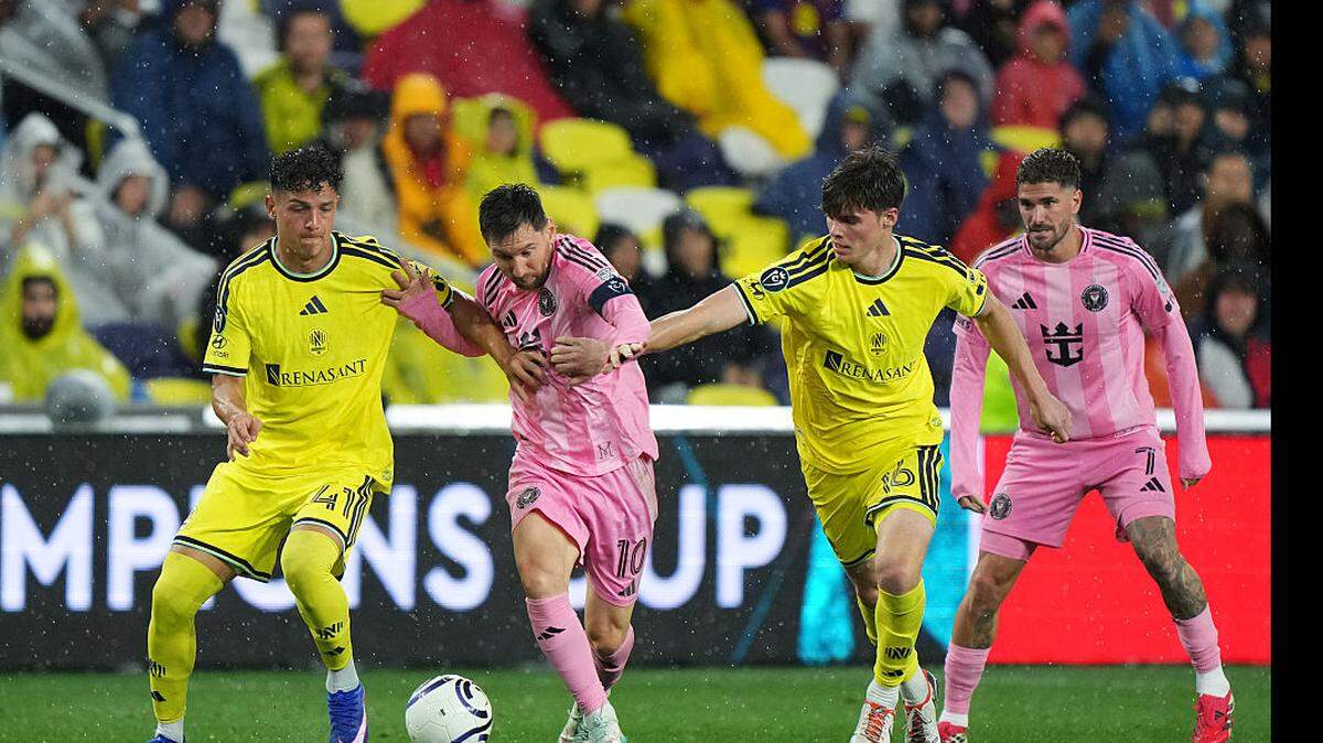 El delantero del Inter Miami Lionel Messi es marcado por Warren Madrigal (izq.) y Matthew Corcoran, de Nashville SC, durante el partido de la Liga de Campeones de la Concacaf celebrado el 11 de marzo de 2026 en el GEODIS Park en Nashville, Tennessee. 