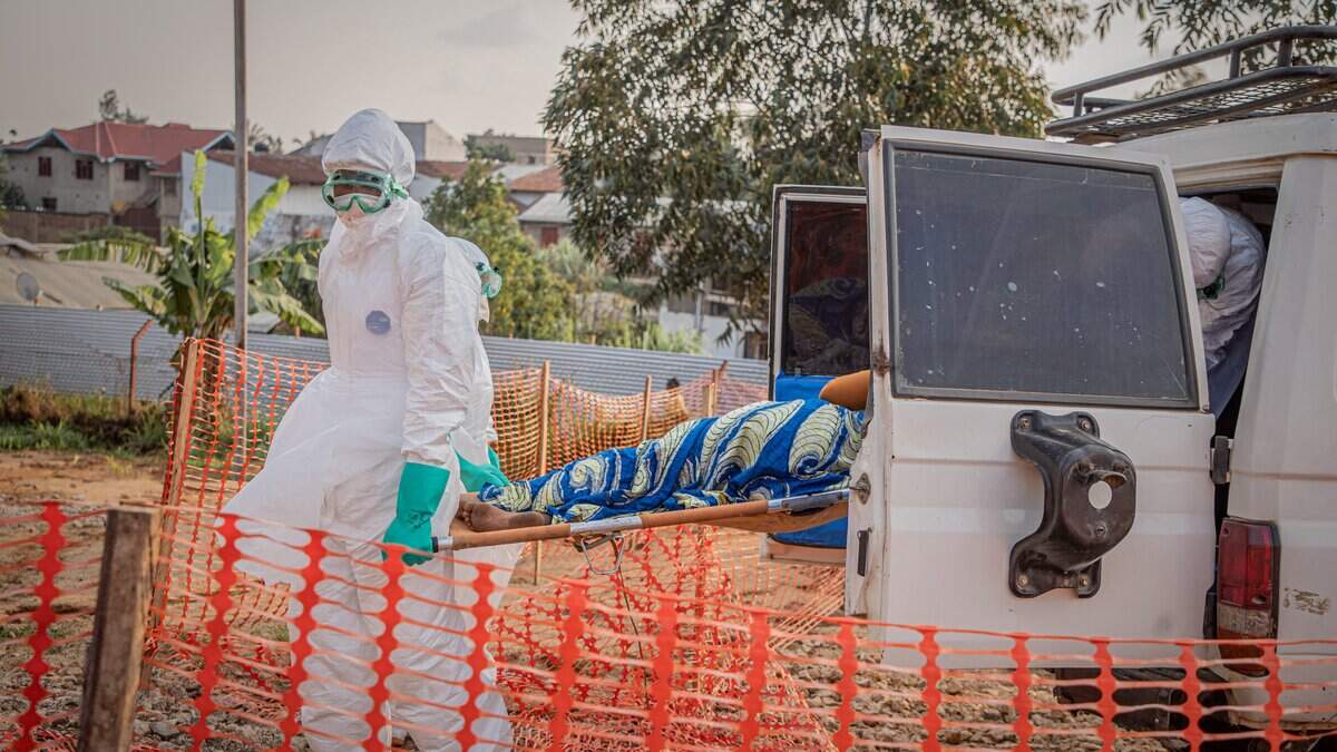 Healthcare workers carry on a stretcher a patient suffering from the Ebola virus disease from an ambulance at the Ebola Treatment Center (ETC) in Bunia, Ituri, in the east of the Democratic Republic of Congo on June 23, 2026. (Photo by Benediction MURHABAZI / AFP via Getty Images)