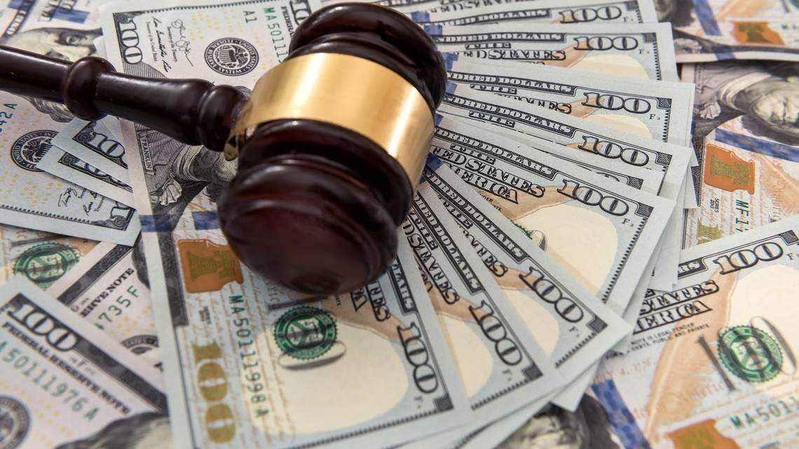 An executive assistant accused of bilking her company out of $8.5 million and splurging on herself was sentenced to prison, federal officials say.