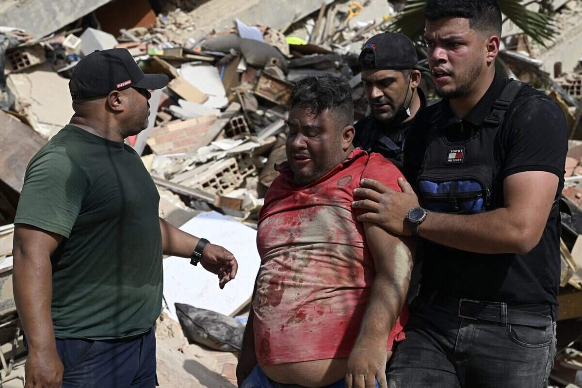 Volunteers help a man found amid the rubble following a twin earthquake in Caraballeda, La Guaira state, about 40 km northeast of Caracas, on June 25, 2026. The death toll from twin quakes, measured at magnitudes 7.2 and 7.5, has risen to at least 188, with more than 1,520 others injured, top lawmaker Jorge Rodriguez reported, while residents continue searching for missing relatives. (Photo by Federico PARRA / AFP via Getty Images)