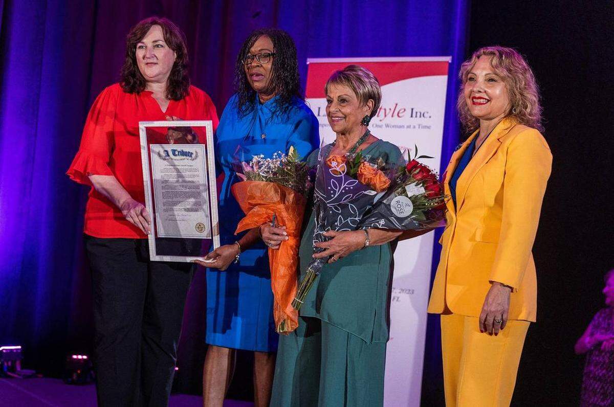 De izquierda a derecha, Christine Hunschofsky, Marie Woodson y la Dra. Rachel Tourgeman, representantes estatales de la Florida, le entregan una proclama de honor a Elaine Miceli-Vasquez, fundadora y presidenta de El Heraldo de Broward.