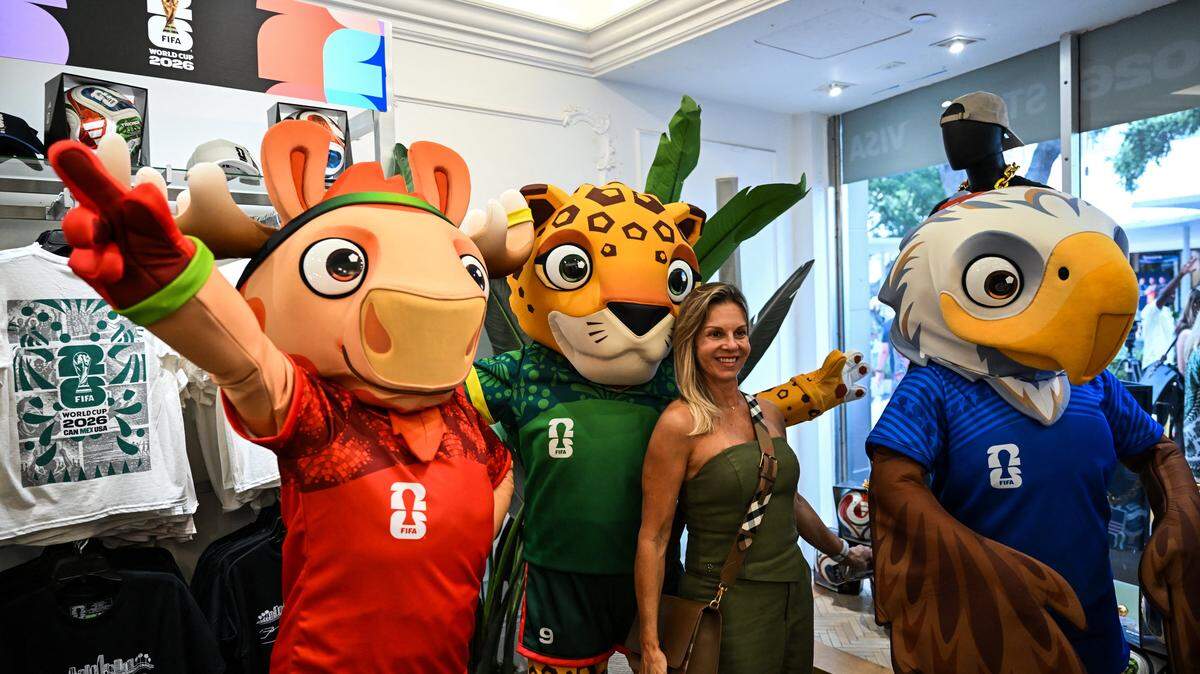 A customer poses with the 2026 FIFA World Cup mascots during the opening day of the official 2026 FIFA World Cup merchandising store in Miami Beach, Florida, on May 18, 2026. (Photo by CHANDAN KHANNA / AFP via Getty Images)