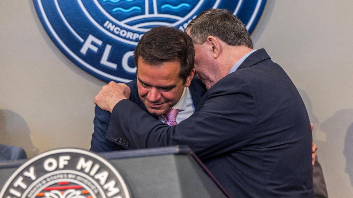 Miami City Commissioner Joe Carollo (right) talks with newly elected Miami City Commissioner Ralph “Rafael” Rosado (center) for District 4 during Rosado’s swearing-in ceremony at City Hall on June 10, 2025.