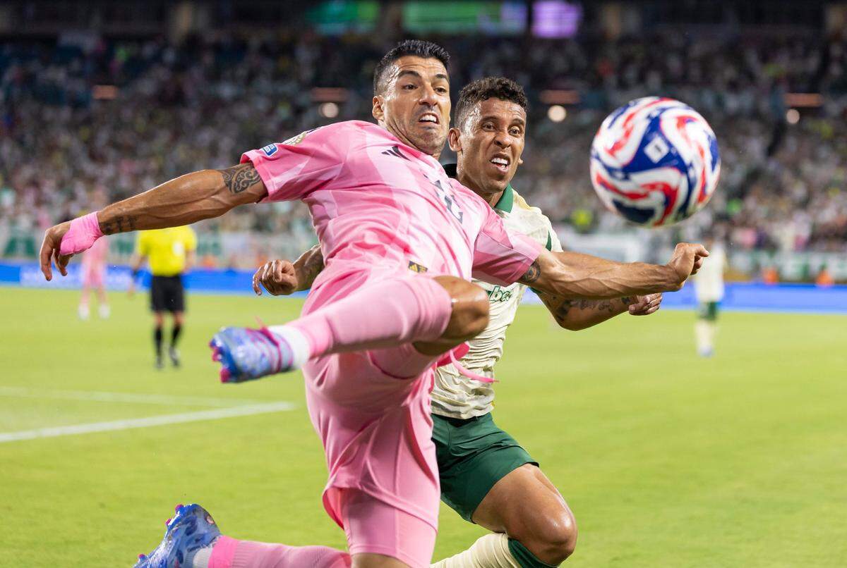 El delantero del Inter Miami Luis Suárez (izq.) patea el balón ante la marca de Marcos Rocha, de Palmeiras, en el partido del Grupo A del Mundial de Clubes, celebrado el 23 de junio de 2025 en el Hard Rock Stadium en Miami Gardens, Florida.