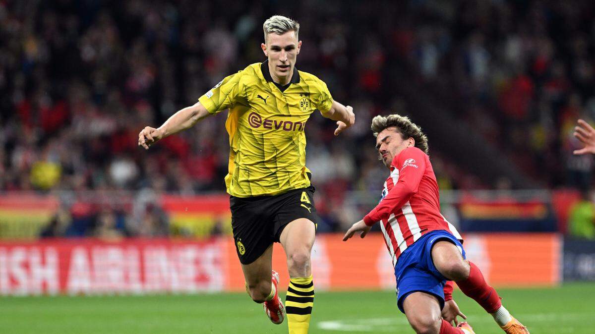El delantero francés del Atlético de Madrid Antoine Griezmann (der.) se erige como el faro hacia el que todo su equipo mira de cara al duelo en Dortmund este martes, en el partido de vuelta de la Liga de Campeones.