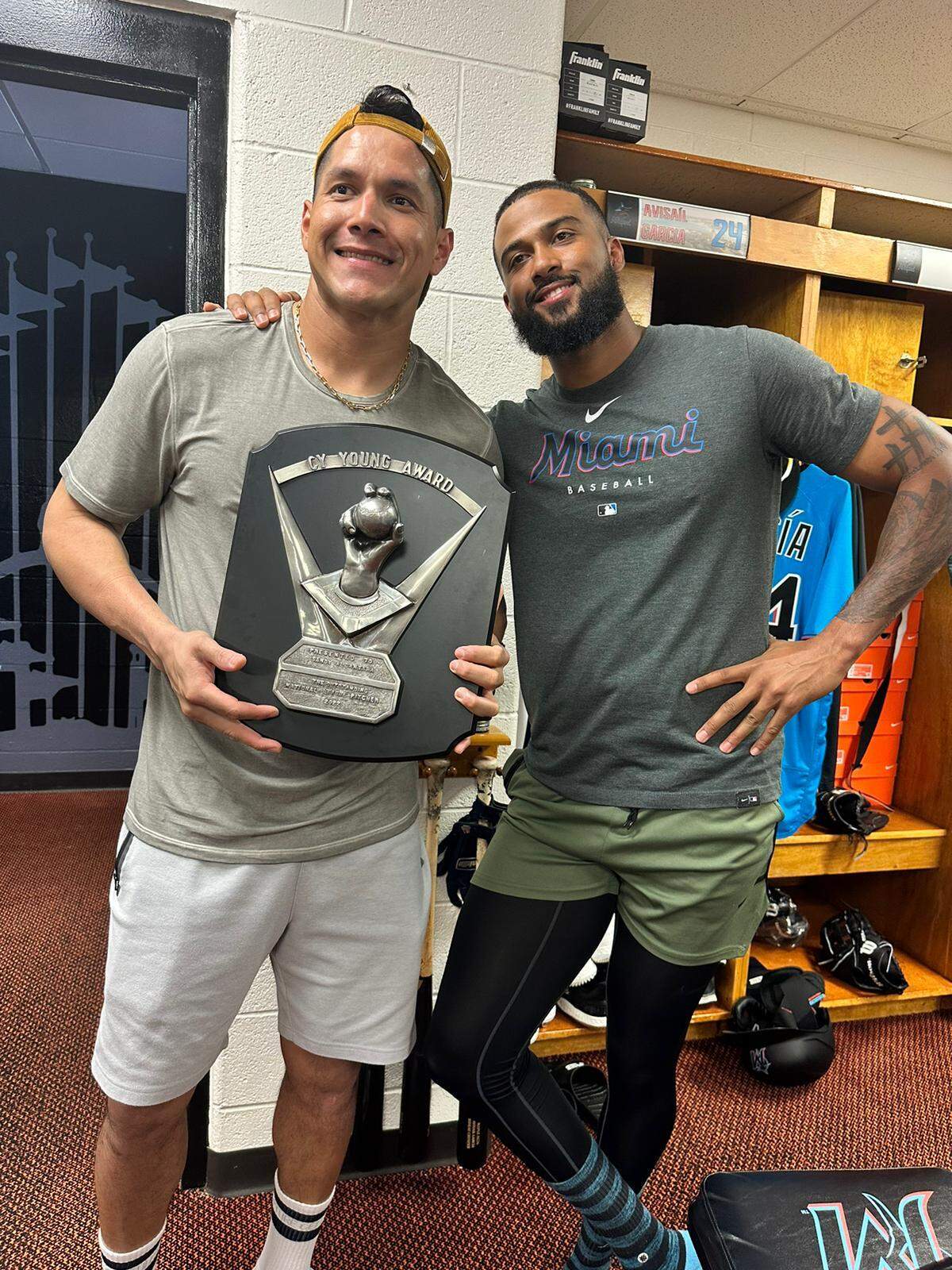 Avisail García sostiene la placa del Cy Young junto a su ganador Sandy Alcántara.