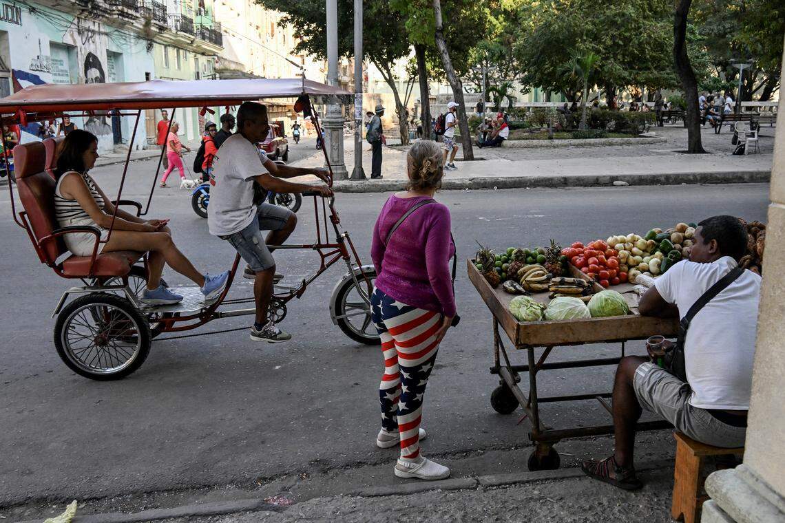 A woman wearing leggings with the U.S. flag stands in the street in Havana on February 26, 2026. Everyday tasks like buying food or medicine become a nightmare in Cuba. The elderly who are unable to move face the worst conditions.