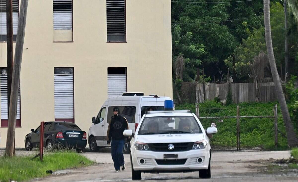 Police officers guard the entrance to the Marianao People's Municipal Court in Havana, on November 11, 2025, where the trial of Cuban former Economy Minister Alejandro Gil is being held. Gil, 61, who served as minister of economy and planning from 2019 until his removal in February 2024, is charged with espionage and various other crimes including bribery, embezzlement and tax evasion. Espionage in Cuba is punished with prison sentences ranging from 10 to 30 years, life imprisonment, and even death. (Photo by Yamil LAGE / AFP) (Photo by YAMIL LAGE/AFP via Getty Images)