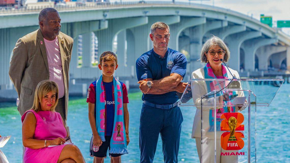 Hard Rock Stadium in Miami Gardens is scheduled to host World Cup games in 2026. At this June 11, 2025, “One Year Out” celebration in downtown Miami, local leaders gathered to cheer the coming soccer matches. Standing from left to right: Miami Gardens Mayor Rodney Harris and city of Miami Mayor Francis Suarez with his son Andrew Xavier, Miami-Dade County Mayor Daniella Levine Cava. Seated is Alina T. Hudak, president of the local World Cup organizing committee.