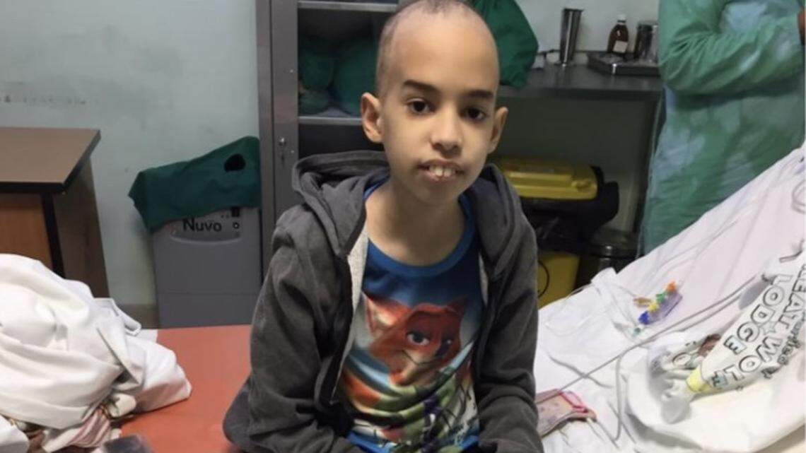José Camilo Cateura Díaz is a Cuban boy who is facing an aggravated case of blood cancer. He is seen sitting on a stretcher at the Institute of Hematology and Immunology in Havana, Cuba.