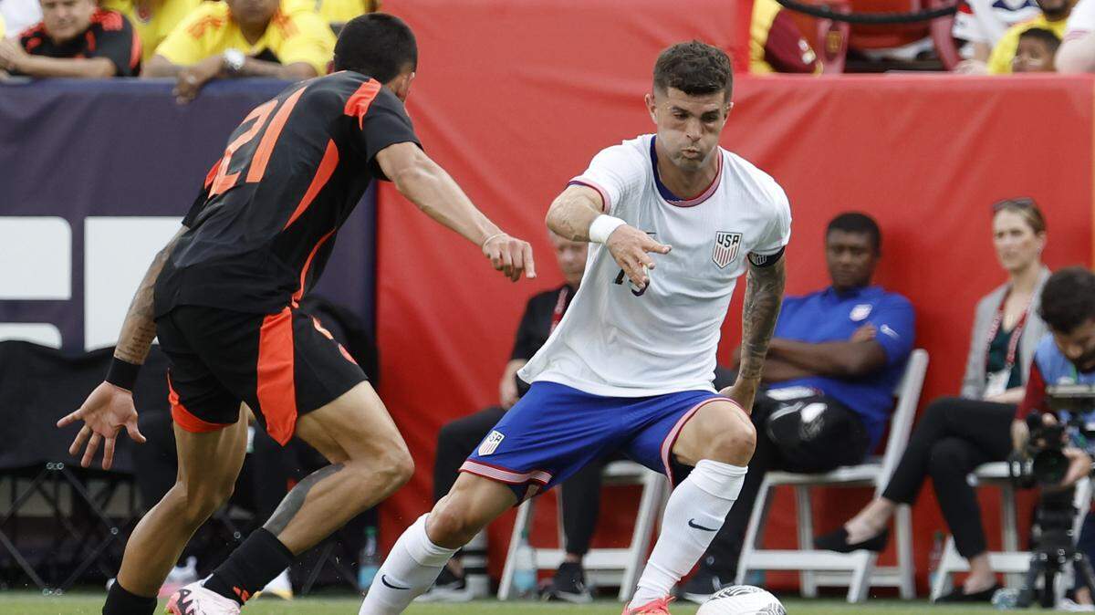 El delantero de Estados Unidos Christian Pulisic (der.) trata de pasar la marca de Daniel Muñoz, de Colombia, en el partido amistoso celebrado el 8 de junio de 2024.