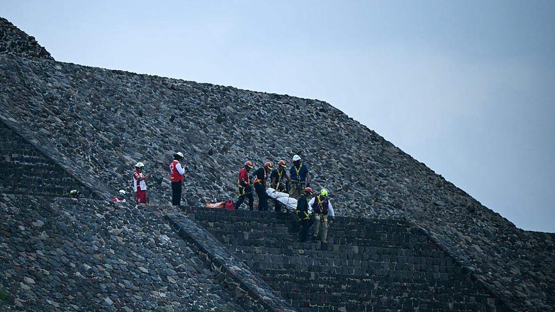 Expertos forenses y miembros de la Cruz Roja trasladan un cuerpo en la Pirámide de la Luna, en la zona arqueológica de Teotihuacán, tras un tiroteo ocurrido en Teotihuacán, Estado de México, el lunes 20 de abril de 2026. Una mujer canadiense fue asesinada a tiros por un hombre que posteriormente se suicidó, según informaron las autoridades.