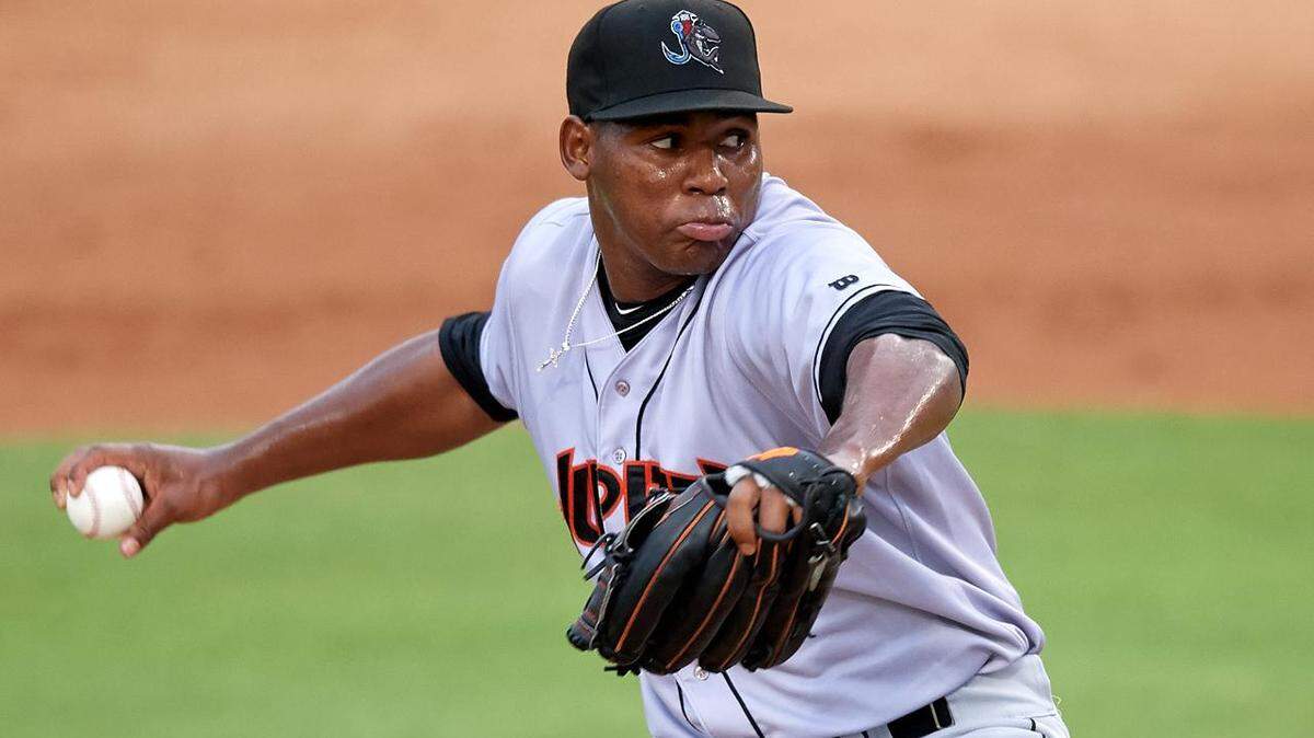The Marlins added pitching prospect Jorge Guzman to their 40-man roster on Tuesday.