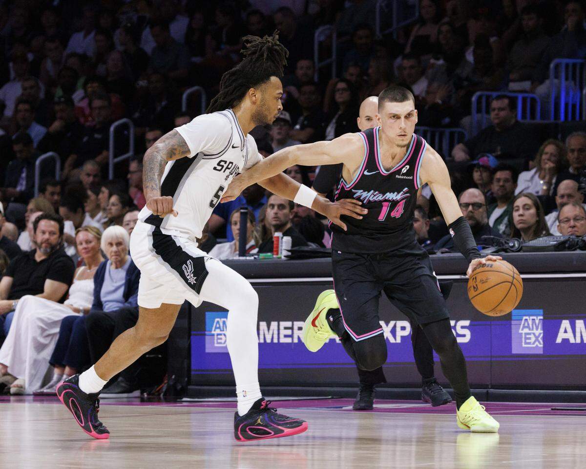 El escolta del Heat Tyler Herro (der.) trata de pasar la marca de Stephon Castle, de los Spurs de San Antonio, en el partido de la NBA celebrado el 23 de marzo de 2026 en Miami. 