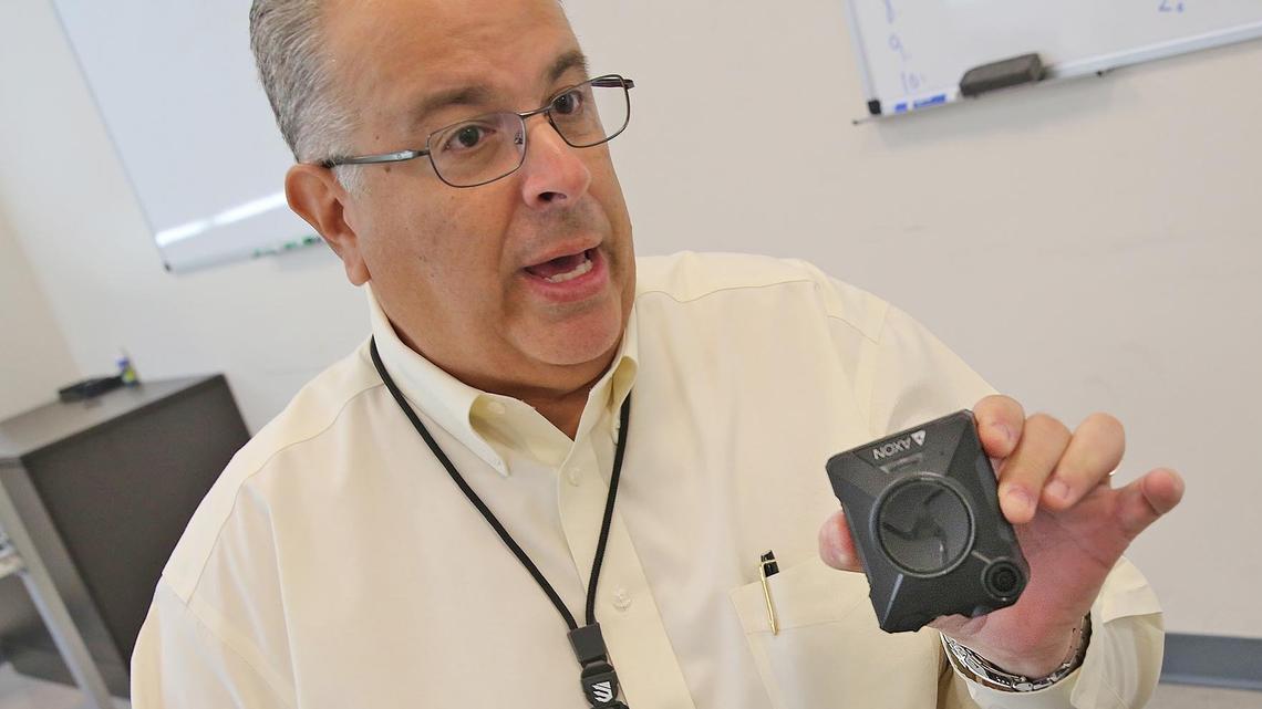 Rey Valdés, spokesman for the Doral Police Department, shows one of the body cameras that the department bought with federal money and has distributed to about 100 officers on patrol and traffic control duty.