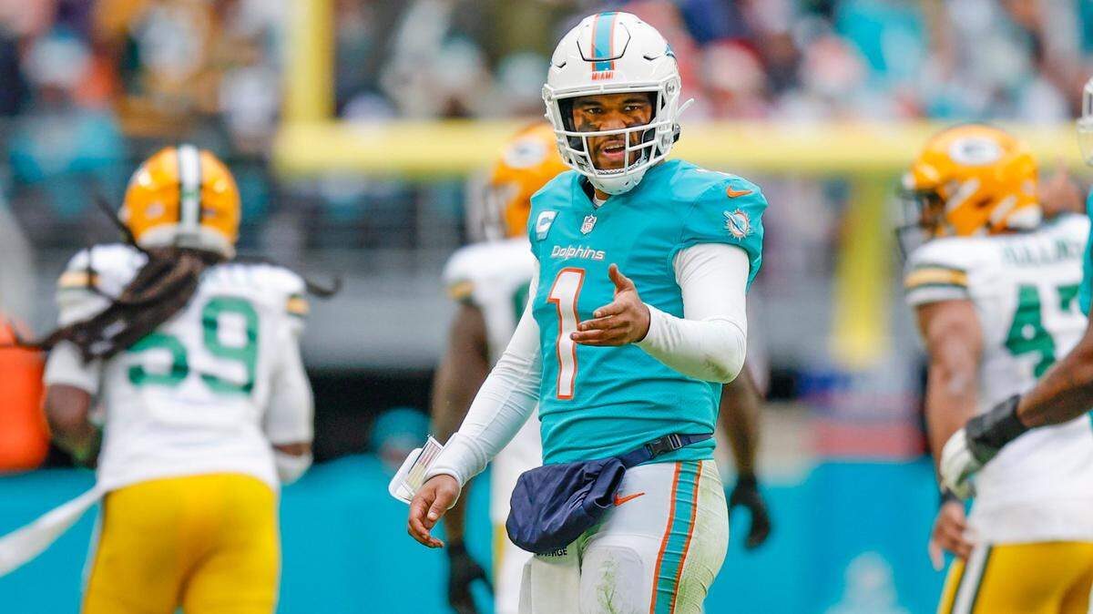 Miami Dolphins quarterback Tua Tagovailoa (1) gestures as Green Bay Packers linebacker De’Vondre Campbell (59) celebrates after intercepting Tua’s pass in the fourth quarter at Hard Rock Stadium in Miami Gardens, Florida on Sunday, December 25, 2022.