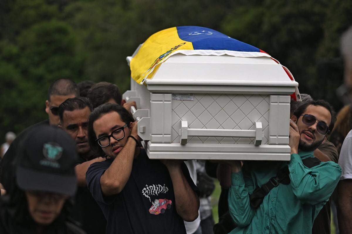 Relatives and members of the civil society carry the coffin of Carmen Navas, mother of late political prisoner Victor Quero Navas, during her burial in Caracas, on May 18, 2026. The mother of Venezuelan political prisoner Victor Hugo Quero Navas died on May 17, 2026 at age 81, just days after confirming the death of her son in state custody, her relatives told AFP. (Photo by Juan BARRETO / AFP via Getty Images)