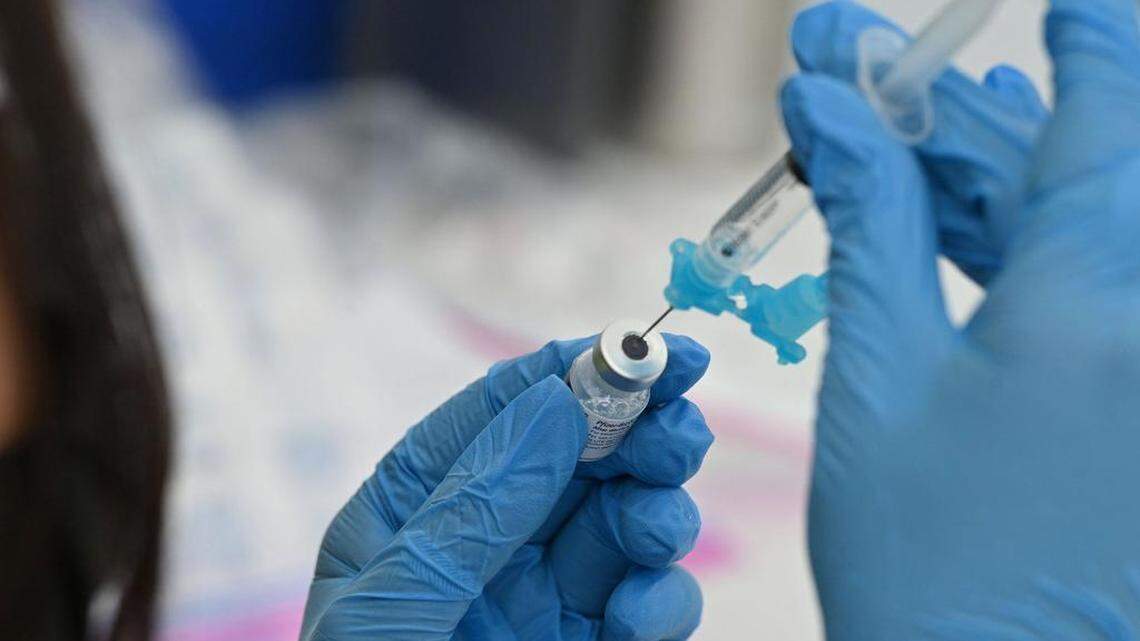A healthcare worker fills a syringe with Pfizer Covid-19 vaccine at a community vaccination event in Los Angeles, California, August 11, 2021.