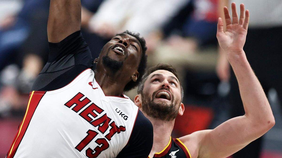 Miami Heat’s Bam Adebayo (13) grabs a rebound against Cleveland Cavaliers’ Kevin Love (0) during the first half of an NBA basketball game, Saturday, May 1, 2021, in Cleveland. (AP Photo/Ron Schwane)